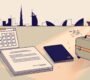 Desk with a calendar, passport, suitcase, contract, and UAE skyline silhouette.